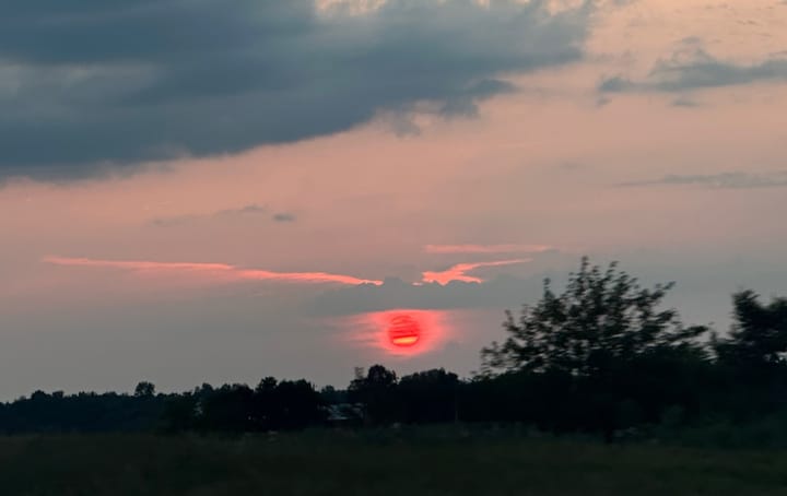 Sun setting in Indiana through a haze of wildfire smoke. 